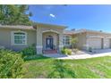 Lovely home with well-maintained landscaping and an inviting covered entrance at 2113 Golf Manor Blvd, Valrico, FL 33596