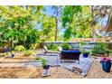 Serene backyard with a paver patio, comfortable seating, and a beautifully landscaped garden at 2501 Crescent Dr, Largo, FL 33770