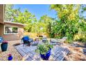Relaxing backyard patio area featuring comfortable outdoor seating and lush tropical landscaping at 2501 Crescent Dr, Largo, FL 33770