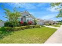 Well-maintained home with lush greenery, featuring a vibrant front yard and a brick paver driveway at 2511 Early Dawn Ct, Valrico, FL 33594