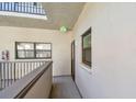 A view of the hallway and the entrance door; 'exit' sign is visible at 2650 Countryside Blvd # C203, Clearwater, FL 33761