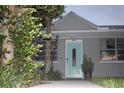Charming home featuring a light blue front door with decorative glass and well-maintained landscaping at 3905 N Highland Ave, Tampa, FL 33603