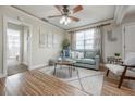 Cozy living room with a comfortable sofa, neutral decor, ceiling fan, and ample natural light from the large window at 3905 N Highland Ave, Tampa, FL 33603