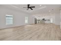Spacious living room with wood floors, plenty of natural light, and an open layout to the kitchen at 4021 Ohio Ave, Tampa, FL 33616