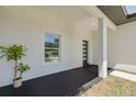 Inviting front porch with a modern front door, fresh paint, and a view of the neighborhood at 4021 Ohio Ave, Tampa, FL 33616