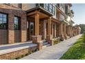 Charming townhome entrances with brick columns and landscaped walkways at 409 E Oak Ave # 9, Tampa, FL 33602