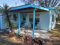 Covered patio with outdoor seating and grill, ideal for enjoying the backyard at 5220 72Nd N St, St Petersburg, FL 33709