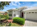 View of the front of this home showing the landscaped beds with plants at 719 Straw Lake Dr, Brandon, FL 33510