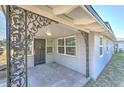 Front porch area with decorative metal supports and front door entrance at 905 W Ball St, Plant City, FL 33563