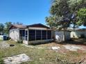 Exterior of the home with view of the backyard, showing a screened patio at 9355 Pinero St, Spring Hill, FL 34608