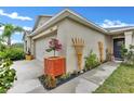 Beautiful home exterior showing landscaped walkway with decorative wooden trellises, leading to the front door at 10936 Rainbow Pyrite Dr, Wimauma, FL 33598