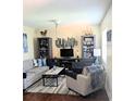 Cozy living room features a soft sofa, chair, entertainment center, and stylish decor for a comfortable space at 120 S Church Ave # 207, Tampa, FL 33609