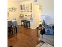 Inviting living space featuring hardwood floors and bar seating to kitchen at 120 S Church Ave # 207, Tampa, FL 33609