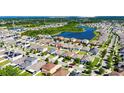 Aerial view of a residential area with a lake, with the property marked by a red pin at 12123 Ledbury Commons Dr, Gibsonton, FL 33534