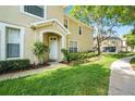 Inviting front entrance with a white door, manicured landscaping, and a well-maintained walkway at 14936 Salamander Pl, Tampa, FL 33625