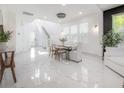 Open-concept dining room features marble floors, staircase, and large windows at 19554 Roseate Dr, Lutz, FL 33558