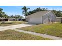 Charming single-story home with a well-maintained lawn and attached two-car garage at 1985 Hastings Dr, Clearwater, FL 33763