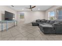 Spacious living room with tile floors, a ceiling fan, and ample natural light at 212 28Th S St, St Petersburg, FL 33712