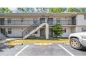 Apartment complex with exterior staircase, black railings, and parking spots at 2122 Bradford St # 505, Clearwater, FL 33760