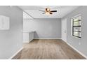 The living room offers gray paint, new vinyl flooring, and ceiling fan with a view to the kitchen at 2122 Bradford St # 505, Clearwater, FL 33760