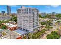 Modern white condo building featuring contemporary architecture, large windows, and surrounding greenery at 226 5Th N Ave # 605, St Petersburg, FL 33701