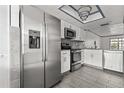 Modern kitchen with stainless steel appliances, white cabinets, and updated countertops at 2275 62Nd N Ave # 5202, St Petersburg, FL 33702