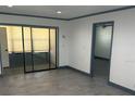 Well lit living room featuring a large sliding glass door, and updated flooring at 2275 62Nd N Ave # 5202, St Petersburg, FL 33702