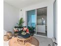 Balcony seating area with an ocean view leads into a modern, open-concept living space at 2910 W Barcelona St # 1902, Tampa, FL 33629