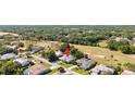 Aerial view of the property showcasing its location near a golf course and lush greenery at 30247 Fairway Dr, Wesley Chapel, FL 33543