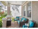 Comfortable patio with stylish wicker furniture, bright cushions, and a small table, perfect for relaxing outdoors at 3325 W Wallcraft Ave, Tampa, FL 33611