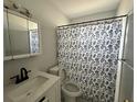 Cozy bathroom with shower featuring white tile, vanity, and sink at 3599 66Th N Way, St Petersburg, FL 33710