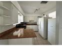 Bright kitchen featuring white cabinets and complementary countertops at 3599 66Th N Way, St Petersburg, FL 33710