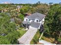 Stunning aerial view of a two-story home surrounded by lush greenery at 4251 W Roland St, Tampa, FL 33609
