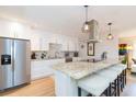 Modern kitchen features stainless steel appliances, granite countertops, and a center island with seating at 4516 S Trask St, Tampa, FL 33611