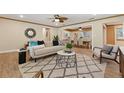 Inviting living room with hardwood floors, a modern sofa, stylish rug, and natural light at 4926 Camellia S Way, St Petersburg, FL 33705