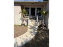 Inviting front porch with palm trees, seating, and a walkway leading up to the main entrance at 5151 22Nd N Ave, St Petersburg, FL 33710