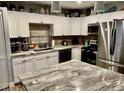 Bright kitchen featuring white cabinets, granite countertops, stainless steel appliances, and an island at 5151 22Nd N Ave, St Petersburg, FL 33710