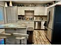 Modern kitchen with stainless steel appliances, white cabinets, butcher block countertops, and a kitchen island at 5151 22Nd N Ave, St Petersburg, FL 33710