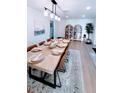 Bright dining room featuring modern light fixture, a large table, and stylish decor at 6337 Cocoa Ln, Apollo Beach, FL 33572