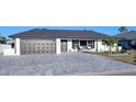 Charming home featuring a well-maintained brick driveway, attached garage, and manicured landscaping at 6337 Cocoa Ln, Apollo Beach, FL 33572