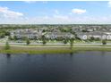 Picturesque community view showcasing well-maintained townhomes near a serene pond, blending nature and neighborhood charm at 6337 Shore Vista Pl, Apollo Beach, FL 33572