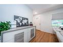 Bright entryway with wood floors, modern console table, and view to the front door at 7241 56Th N Ave, St Petersburg, FL 33709