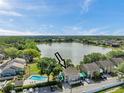 Aerial view showcases the property's location near a serene lake, community pool, and lush greenery at 8719 Lake Place Ln, Tampa, FL 33634