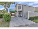 Charming home exterior features a carport, well-maintained landscaping, and a welcoming entrance at 8719 Lake Place Ln, Tampa, FL 33634