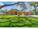 Stunning single-story home with lush landscaping and a spacious driveway at 8933 Crescent Forest Blvd, New Port Richey, FL 34654
