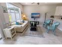 Inviting living room with a neutral sofa, stylish furniture, and a large window at 9660 Sweetwell Pl, Riverview, FL 33569