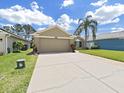 Charming home featuring an attached two-car garage and long driveway lined by a brick trim at 2452 Big Pine Dr, Holiday, FL 34691