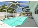 Enjoy outdoor living with this sparkling screened-in pool, perfect for relaxation and entertainment at 10314 Lake Carroll Way, Tampa, FL 33618