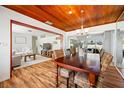 Dining room open to the living room and kitchen featuring wood ceilings and wicker chairs at 10821 101St Ave, Seminole, FL 33772