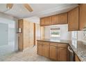 Kitchen with a large island featuring granite countertops and wooden cabinetry for storage and ample prep space at 1153 Honor Dr, Holiday, FL 34690